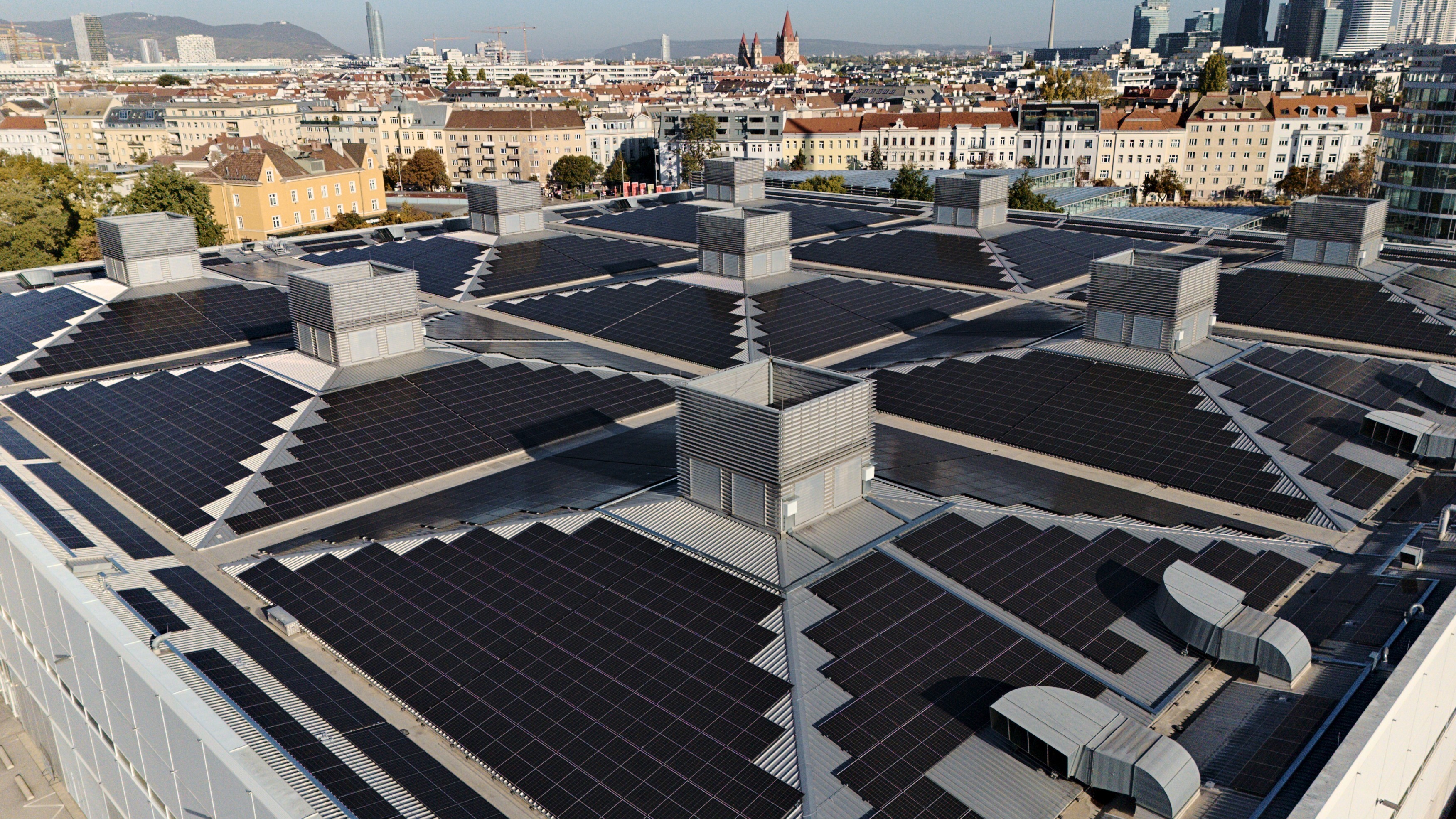 Aerial view of the entire VIECON Messe Wien rooftop solar array, looking toward Leopoldstadt