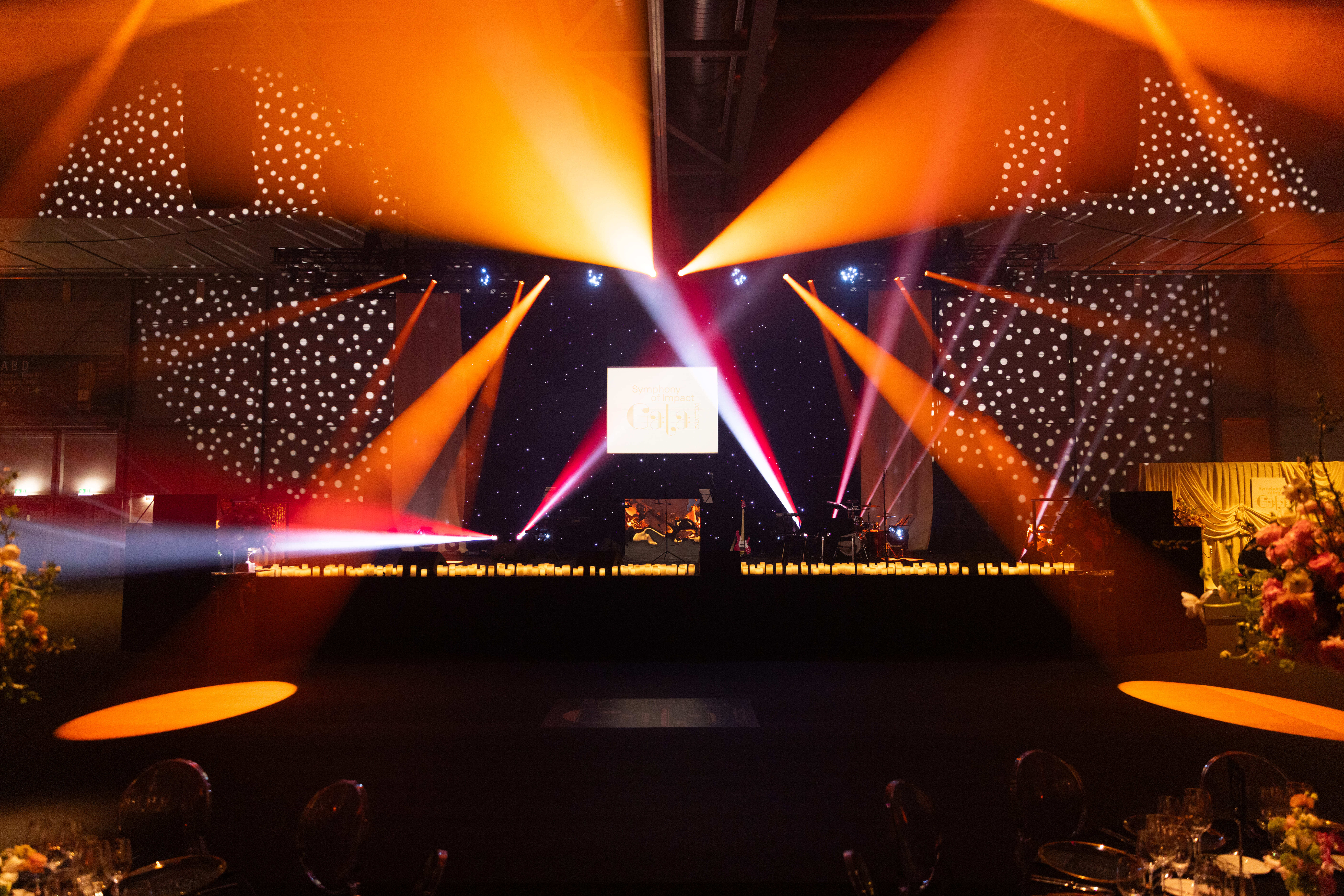 Event stage with dynamic lighting design and LED visuals in a large venue